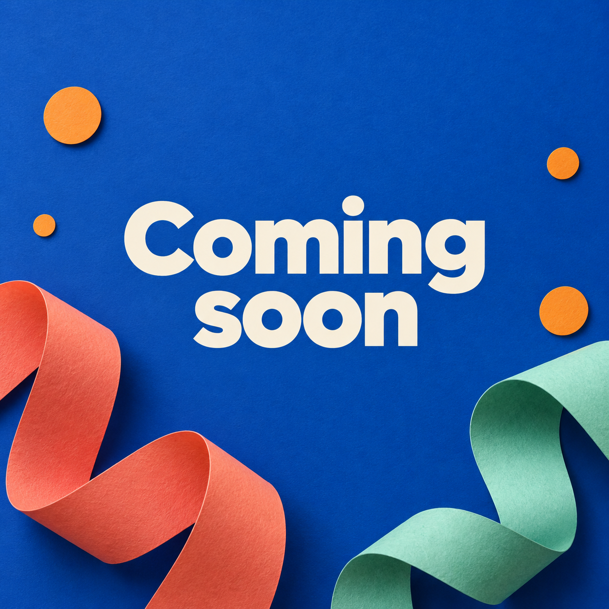 Cream coming soon lettering on cobalt paper with coral and mint folded ribbons